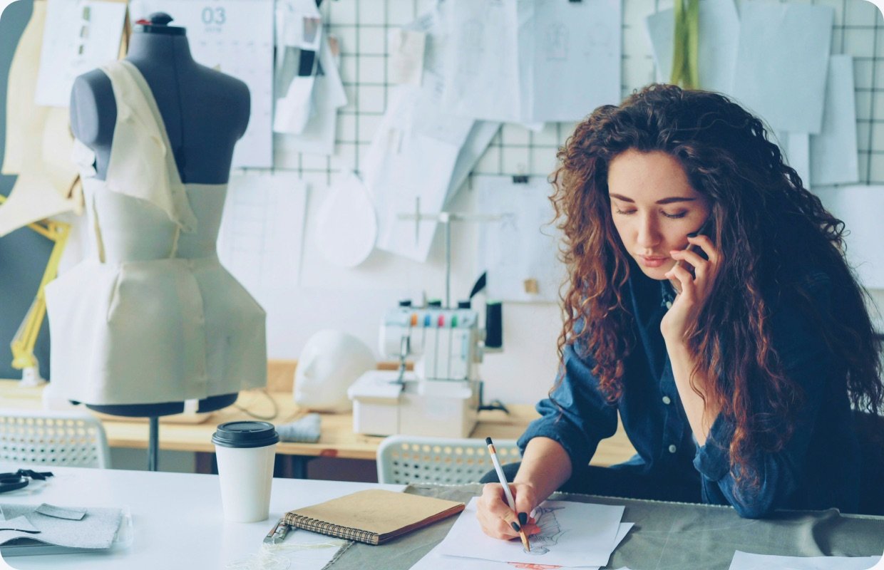 A small-business owner shaping their brand — the work First Brick supports